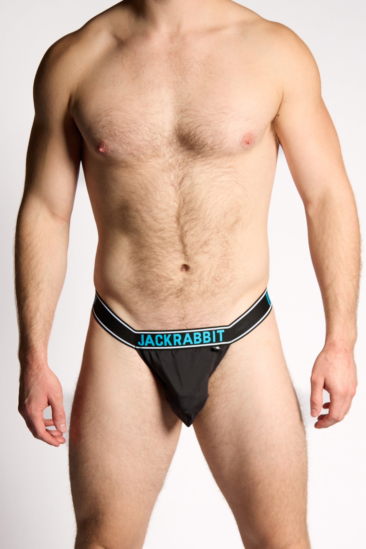 Man wearing black men's underwear with 'Jackrabbit' branding on a white background