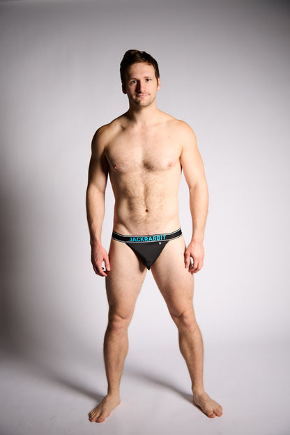 Man wearing a black underwear with 'Jackrabbit' branding on a gray background