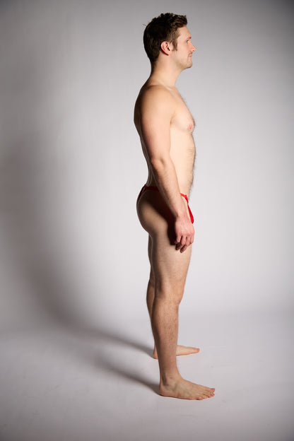 Man standing with a neutral expression on a gray background