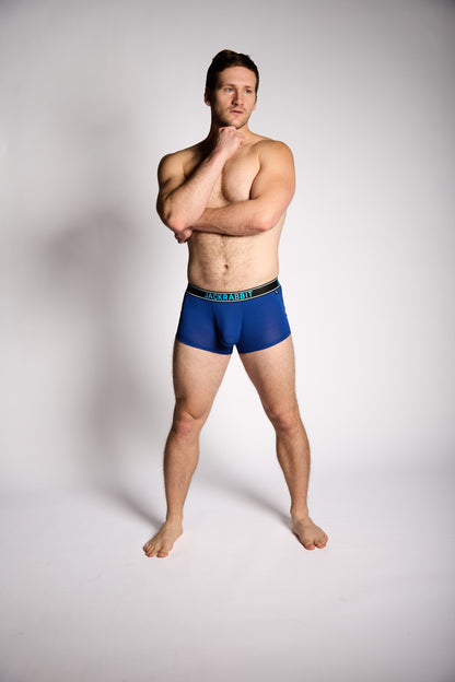 Man wearing blue underwear on a plain background