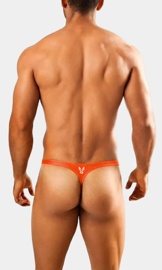 Man wearing an orange thong on a white background