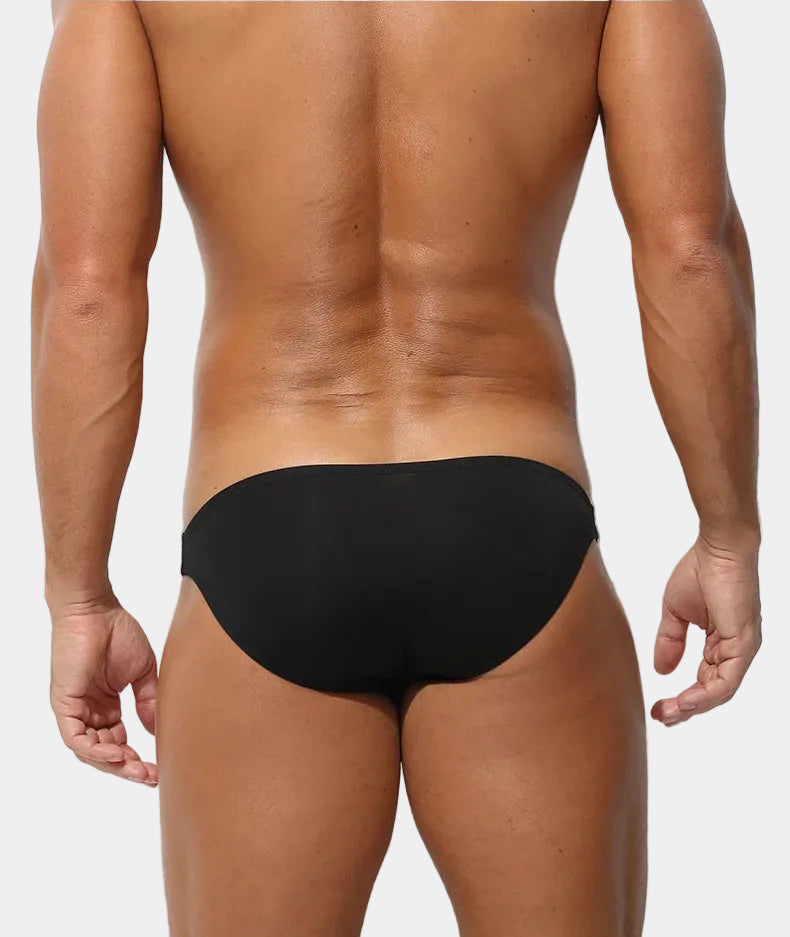 Person wearing a black underwear with text on a white background