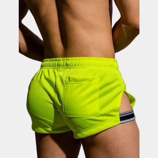 Person wearing bright green shorts on a plain background